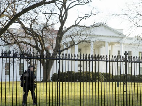 A member of the Secret Service walks the perimeter of the North Lawn of the White House in Washington, last March. On Friday night, an intruder entered the White House grounds while the President was home.


